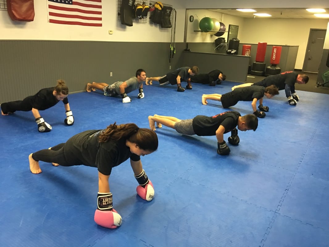 Mixed Martial Arts adult class working on strength, fitness, conditioning, and health.